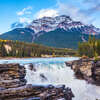 bigstock-Powerful picturesque waterfall Athabasca. Pyramidal mountain covered with the snow. Canada, Jasper National Park.jpg