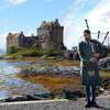 640px-Piper_at_Eilean_Donan_Castle,_Scotland.JPG